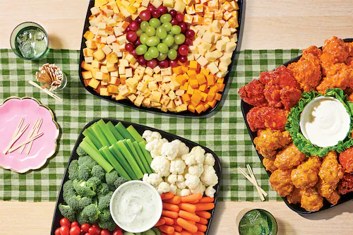 Variety of sub platters on a green checkerboard  table cloth